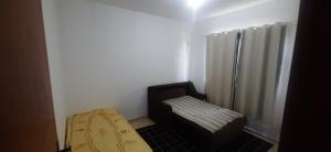 a small room with a chair and a shower at A Casa Branca in Rio das Ostras