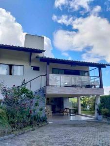 a large house with a balcony and a patio at Casa dos Colibris, Lugar memorável! in Chã Grande