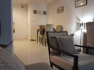 a living room with a chair and a table at Arisara place in Koh Samui