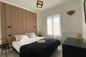 a bedroom with a bed and a desk and a window at Villa TILLA 110 m2, terrasse babyfoot fléchettes in Arcachon