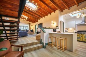 a kitchen and living room with wooden ceilings at The Old Stables - Hot Tub, Sauna and Cinema in Alyth