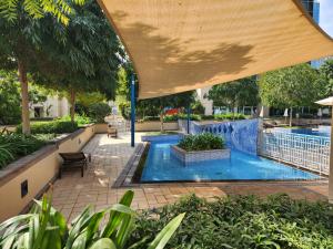 an overhead view of a swimming pool with a large umbrella at Downtown Oasis, Burj Khalifa Views, Luxury Amenities in Dubai