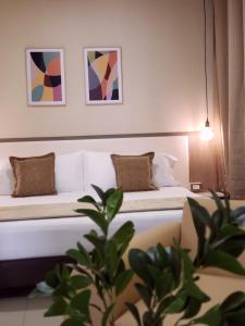 Postel nebo postele na pokoji v ubytování Hotel Suite Center Pereira