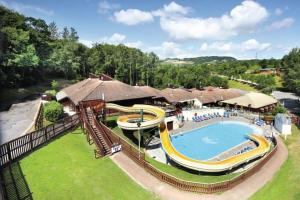 a large swimming pool with a slide in a yard at Luke's Lodge in Newton Abbot