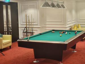 a pool table with balls on it in a room at Downtown Oasis, Burj Khalifa Views, Luxury Amenities in Dubai