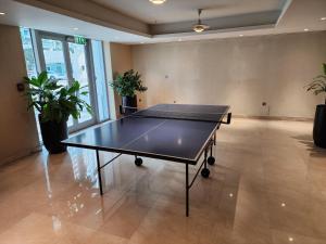 a ping pong table in the middle of a room at Downtown Oasis, Burj Khalifa Views, Luxury Amenities in Dubai