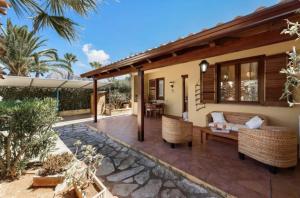 a patio of a house with a couch and chairs at Villa Verabetta in San Vito lo Capo