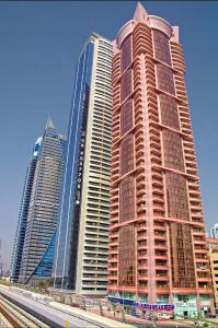 a group of tall buildings in a city at Paz Holiday Luxurious Space in Dubai