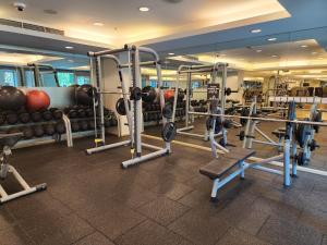 a gym with lots of machines and weights at Downtown Oasis, Burj Khalifa Views, Luxury Amenities in Dubai