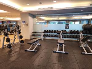 a gym with lots of exercise equipment in a building at Downtown Oasis, Burj Khalifa Views, Luxury Amenities in Dubai