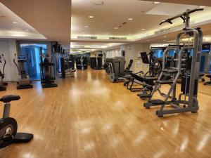 a gym with treadmills and elliptical machines at Downtown Oasis, Burj Khalifa Views, Luxury Amenities in Dubai