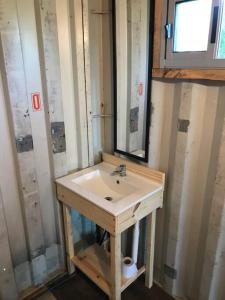 a bathroom with a sink and a mirror at Glamping in Uruguay’s hidden gem in Piriápolis