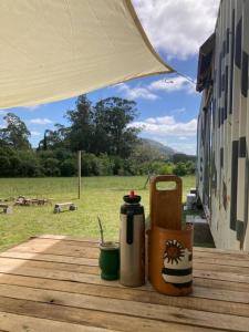 a table with a thermos on it with a view of a field at Glamping in Uruguay’s hidden gem in Piriápolis