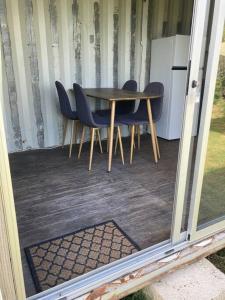 a table and chairs sitting on a patio at Glamping in Uruguay’s hidden gem in Piriápolis