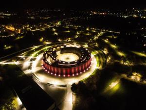 a roundabout with lights in a city at night at Hotel Gromada Medical SPA Busko Zdrój in Busko-Zdrój