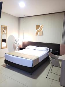 Postel nebo postele na pokoji v ubytování Hotel Suite Center Pereira