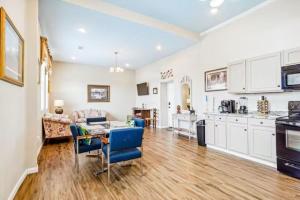 a kitchen and living room with a table and chairs at Penthouse on Claiborne in New Orleans