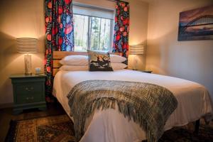 a bedroom with a large bed with a window at Elk Street Retreat - Near Glacier Park in Columbia Falls
