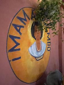 a painting of a woman on a wall at Hostal Mamamambo in Santo Domingo