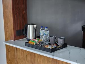 a tray with drinks and food on a counter at Downtown Oasis, Burj Khalifa Views, Luxury Amenities in Dubai