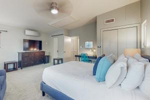 a bedroom with a large white bed and a television at C-Ranch South in San Diego