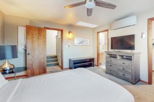a bedroom with a white bed and a television at C-Ranch South in San Diego