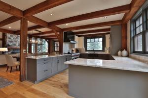 a large kitchen with wooden ceilings and wooden beams at Mountain Village Marvel with Hot Tub and Home Gym! in Telluride