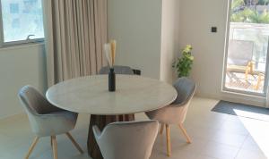 a dining room with a table and chairs at Downtown Oasis, Burj Khalifa Views, Luxury Amenities in Dubai