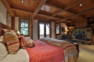 a bedroom with a large bed and a fireplace at Mountain Village Marvel with Hot Tub and Home Gym! in Telluride