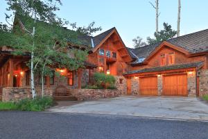 a large wooden house with a garage at Mountain Village Marvel with Hot Tub and Home Gym! in Telluride