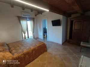 a bedroom with a bed in a room with a door at La Scienza Nuova in Vatolla
