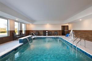 a swimming pool in a hotel with blue water at Fairfield by Marriott Inn & Suites Hillsboro in Hillsboro