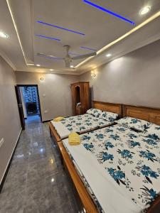a bedroom with two beds and a ceiling at Double A apartment in Ngambo
