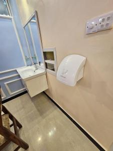 a bathroom with a sink and a mirror at Double A apartment in Ngambo