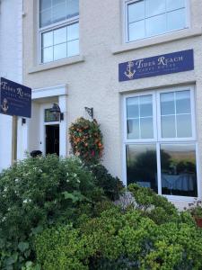 a building with a sign in front of it at Tides Reach Guest House in The Mumbles