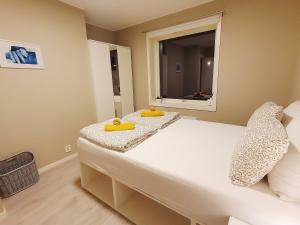 a bedroom with a bed with two yellow objects on it at Beautiful, convenient, central room 2 in Bergen