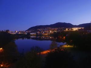 a view of a city and a lake at night at Beautiful, convenient, central room 2 in Bergen
