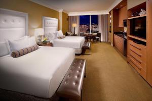 a large hotel room with two beds and a kitchen at Trump International Hotel in Las Vegas