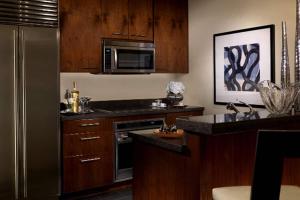a kitchen with wooden cabinets and a stainless steel refrigerator at Trump International Hotel in Las Vegas