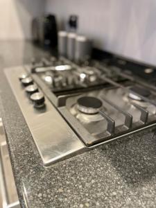 a stove top oven sitting on top of a counter at Central 4 bedroom house in the heart of Birmingham city with Free Parking, and sleeps up to 8! in Birmingham