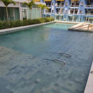a large swimming pool in a large building at Lindo apartamento na Barra in Salvador