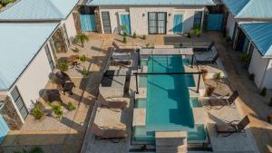 an overhead view of a swimming pool with chairs next to a house at Villas VR Beachwalk Avellanas in Playa Avellana