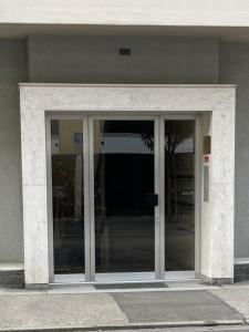 un ingresso a un edificio con porte in vetro di RELAX Ortensia Apartment a Locarno