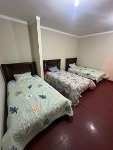two beds sitting next to each other in a room at Be at home in Oruro