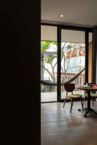 a room with a table and a chair and a window at El Callejón Hotel Boutique in Oaxaca City