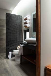 a bathroom with a sink and a toilet at El Callej&oacute;n Hotel Boutique in Oaxaca City