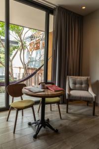 a living room with a table and a chair at El Callejón Hotel Boutique in Oaxaca City