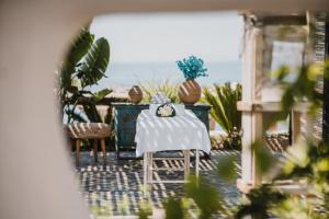 a table with a white table cloth on it at Empire Beach Resort ADULTS ONLY in Dhërmi