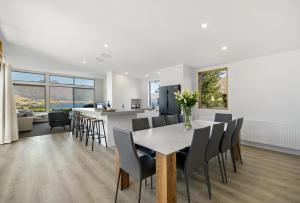 a dining room and kitchen with a table and chairs at Whakata on Whitbourn - Luxury Retreat With Spa in Queenstown