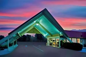 a rendering of a building with a sunset in the background at Econo Lodge in Red Bluff